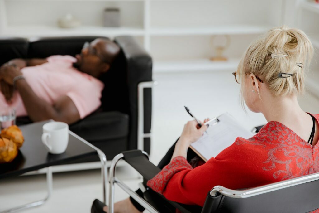 Woman in Red Sweater Sitting on Black Chair
