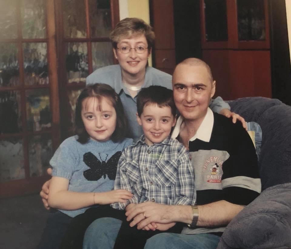 Sharon smiling with her late husband and their two children, embodying the healing power of positive memories in the journey of grief recovery.